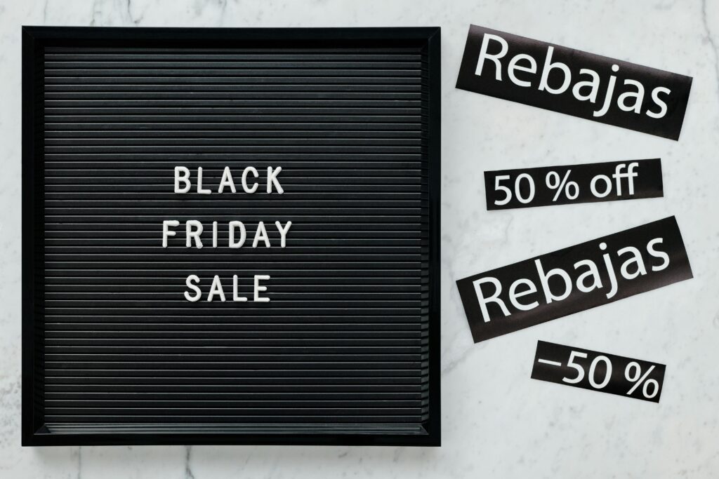 pexels photo 5872178 5872178 Black Friday sale board featuring discounts in English and Spanish for seasonal promotions.